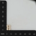 Detail view of gold-plated letter H charm with white cubic zirconia micro-pave setting - Gold H