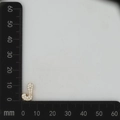 Detailed size measurement of a gold letter J pendant with micro-paved zircons - Gold J