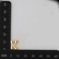 Macro detail of gold 3D bubbly letter K pendant on a measuring scale for DIY jewelry - Letter K Pendant Only (Without Chain) / Gold