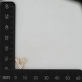 Detail view of gold letter V charm pendant with micro-set zircons on measuring scale - Gold V