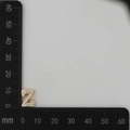 Macro shot of gold letter Z pendant with white zircons showing 15mm height measurement - Gold Z