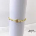 Polished gold beaded bracelet featuring a micro-pave zircon letter A charm on white background - Gold A