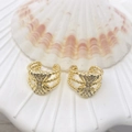 Golden woven twisted ear cuffs with shimmering zircon butterfly detail on shell stand - Bow Twist Style (91) / Gold