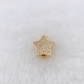 Detailed view of gold-plated star charm with cubic zirconia on white faux fur background - Gold Star (Style 134)