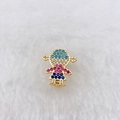 Detailed close-up of a golden girl pendant with colorful zircon stones on white faux fur - Gold Chibi Girl (Style 142)