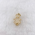 Detailed macro view of a gold girl pendant with sparkling cubic zirconia on plush background - Gold Rhinestone Girl (Style 148)