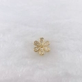 Macro view of a gold flower charm with white zircons on a white plush background - Golden Six-Petal Flower Style (Style 236)