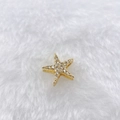 Macro shot of gold starfish pendant with white cubic zirconia on white fur background - Gold Rhinestone Star (Style 152)