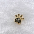 Detailed close-up of gold paw print charm with black micro-pave cubic zirconia inlay - Gold Black Rhinestone Paw (Style 158)