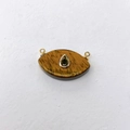 Detail of eye-shaped tiger eye stone pendant with green gemstone and gold plating - Tiger Eye Stone Bracelet