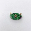 Macro detail of eye-shaped Ruby Zoisite pendant with gold trim and drop stone inlay - Ruby Zoisite