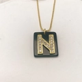 Detail eines schwarzen quadratischen Anhängers mit goldenem Buchstaben N und Zirkon - Buchstabe N (Nur Anhänger) / 20x18 mm / Schwarz