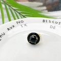 Elegant gold ring with faceted black gemstone and black enamel circle on white ceramic - Faceted Black Stone Style (Style C)
