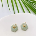 Detail view of hexagonal green aventurine pendants featuring gold butterfly zircon inlay - Amazonite