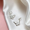 Detailed macro view of silver butterfly pendants with engraved textures and cubic zirconia - Silver Butterfly Style (#5)