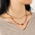 Detail of red agate and natural stone double-layer necklace on a beige knit sweater - Good Fortune (No Metal Chain)