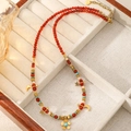 Red beaded necklace with gold moon and star charms and turquoise accents for women - Abundant Flowers