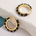 Vintage gold hoop earrings with black natural stone beads on a textured white stone - Gold with Black Beading