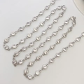 Detail of silver plated chain featuring 4mm round cubic zirconia bezels on white surface - Silver Chain 4mm
