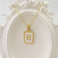 Goldene Edelstahlkette mit einem rechteckigen weißen Muschel-Anhänger und dem Buchstaben H - Buchstabe H / Weiß