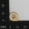 Detail view of 11mm gold letter Q charm with white zircon stones on a scale ruler - Letter Q
