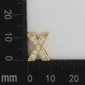 Macro detail of gold-plated letter X pendant with white zircon pavé setting and dimensions - Letter X