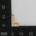 Detailed view of gold letter L pendant with white zircons showing 11mm height on scale - L