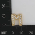 Detailed scale view of 12x11mm gold letter M charm with micro-set white cubic zirconia - M