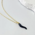 Detailed view of a gold O-chain necklace with a black Italian Cornetto pepper pendant - Black Chili Style