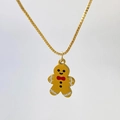 Golden gingerbread man necklace pendant with red bow and white frosting detail - Gingerbread Man Figure Style (Variant O)