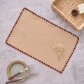 Close-up of natural burlap placemat with dark brown scalloped crochet edge detailing - 30x45cm / Coffee Scalloped Border