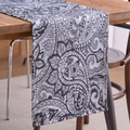 Classic black and white paisley pattern table runner displayed on a wooden dining table - Black Jacquard Paisley / 33x120cm