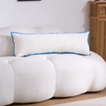 Macro shot of white fabric pillow with blue wave lace trim on a textured sofa - Blue Scalloped Embroidery