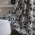 Black and white tropical leaf jacquard chenille curtain draped over a white sofa - 140x160CM / Island Black (Hook Style)