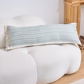 Detail of light green geometric jacquard lumbar pillow with white tassels on a cozy sofa - Green Braid (4568)