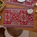 Detailed close-up of a vintage red jacquard floral placemat on a rustic wooden dining table - Single Piece / Red Branch Floral