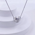 Macro detail of silver heart necklace with crystal letter Z on minimalist white stand - Silver Z