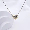 Golden heart pendant necklace with crystal letter C on a minimalist white stand - Gold C