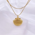 Macro detail of a gold shell pendant on a double layered box chain over white silk - Fan Shell Style / Style B
