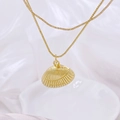 Macro shot of gold shell pendant with box chain on elegant white silk background - Ridged Shell Style / Style C