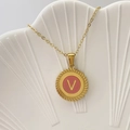 Golden round necklace with pink backing and letter V pendant on white shell tray - Letter V / Pink