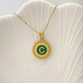 Collana dorata con ciondolo lettera C e intarsio in malachite verde su piatto bianco - Lettera C / Verde