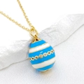 Detail of 14K gold Easter egg pendant with blue enamel stripes and zircon accents - Blue & White