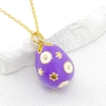 Detailed close-up of purple enamel Easter egg pendant with gold star patterns - Purple