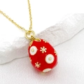 Red Faberge style Easter egg pendant necklace with gold snowflakes on white stone - Red