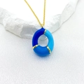 Golden necklace with circular pendant featuring three shades of blue enamel sections - Letter O Style