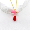 Golden necklace featuring a vibrant red and pink enamel bubble letter T pendant - Letter T Style