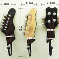 Set of 3 vintage guitar head wall hooks in black and gold finish, height 19cm - Guitar Headstock Style (E22-F000397)