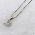 Detailed view of silver letter D pendant necklace featuring micro-paved cubic zirconia - Silver D