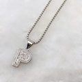 Macro shot of silver letter P pendant with baguette-cut and micro-pave zircons - Silver P